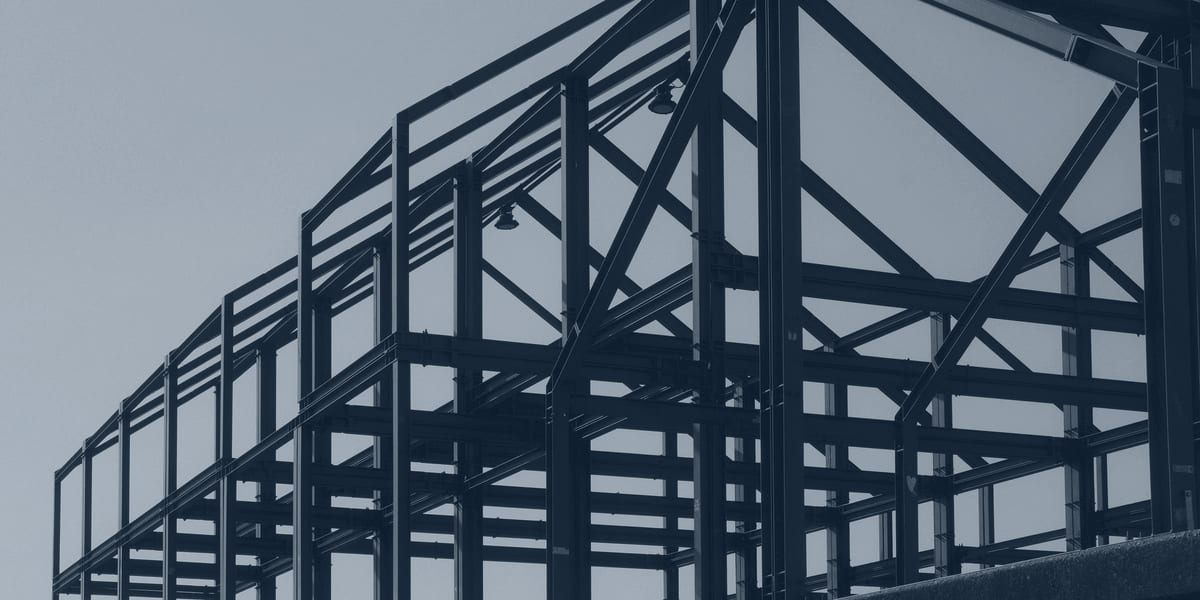Structural steel frame rising against open sky, the earliest critical-path trade on a data-center build.